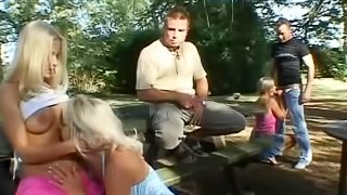 Hot outdoor gang bang with three horny ladies and two huge cocked dudes