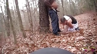 White streetslut sucks off a fat black guy in the forest