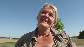 Old lady parks her car in an empty field to fuck a dildo